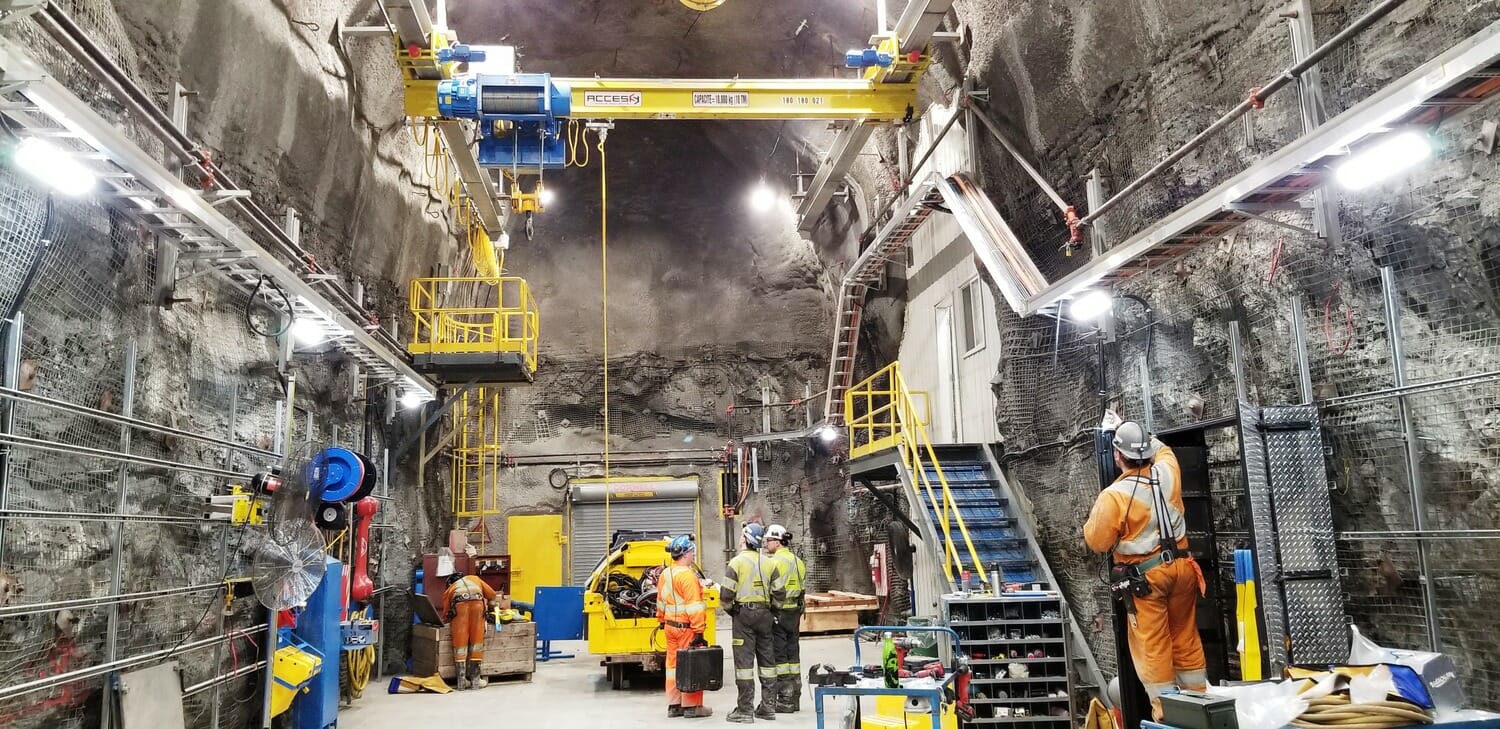 A group of workers are working in a tunnel.
