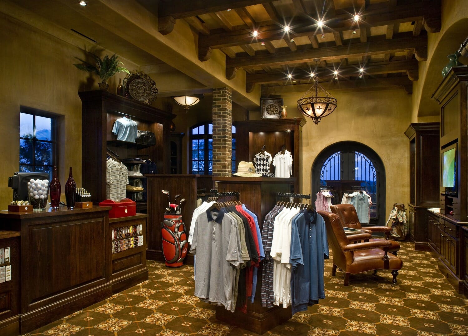 A golf shop with a lot of clothes on display.