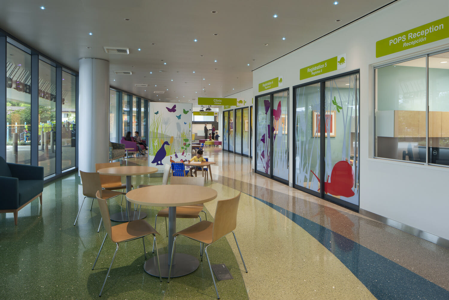 A hallway with tables and chairs.