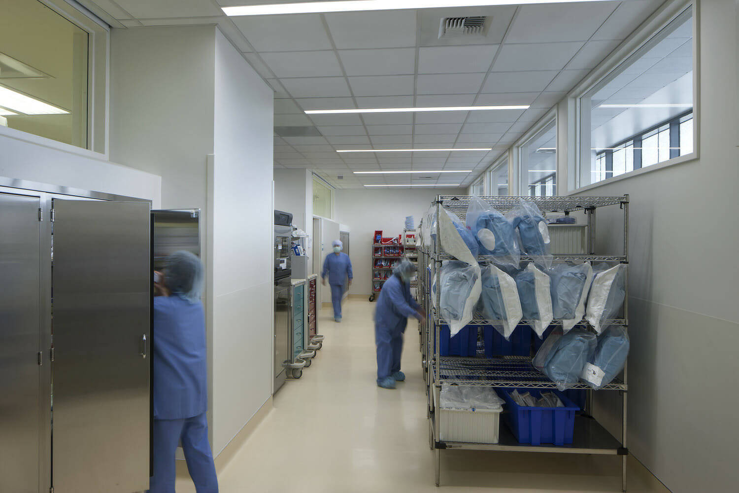 A group of people in scrubs walking down a hallway.