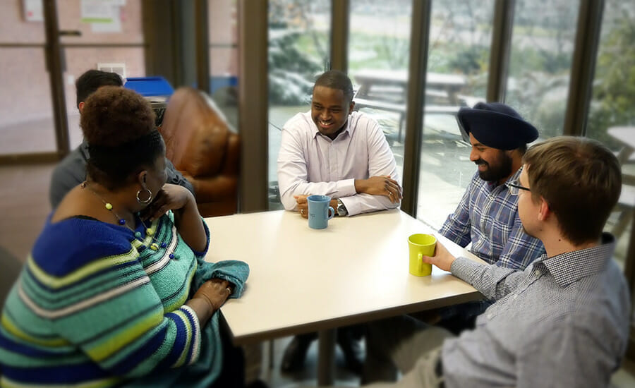 A group of people sitting around a table.