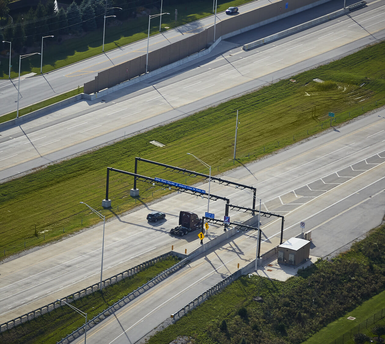 An aerial view of a highway with a toll booth.