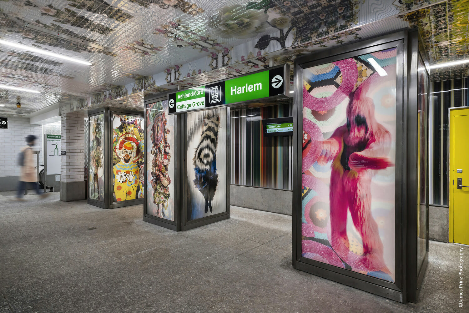 A subway station with colorful paintings on the walls.