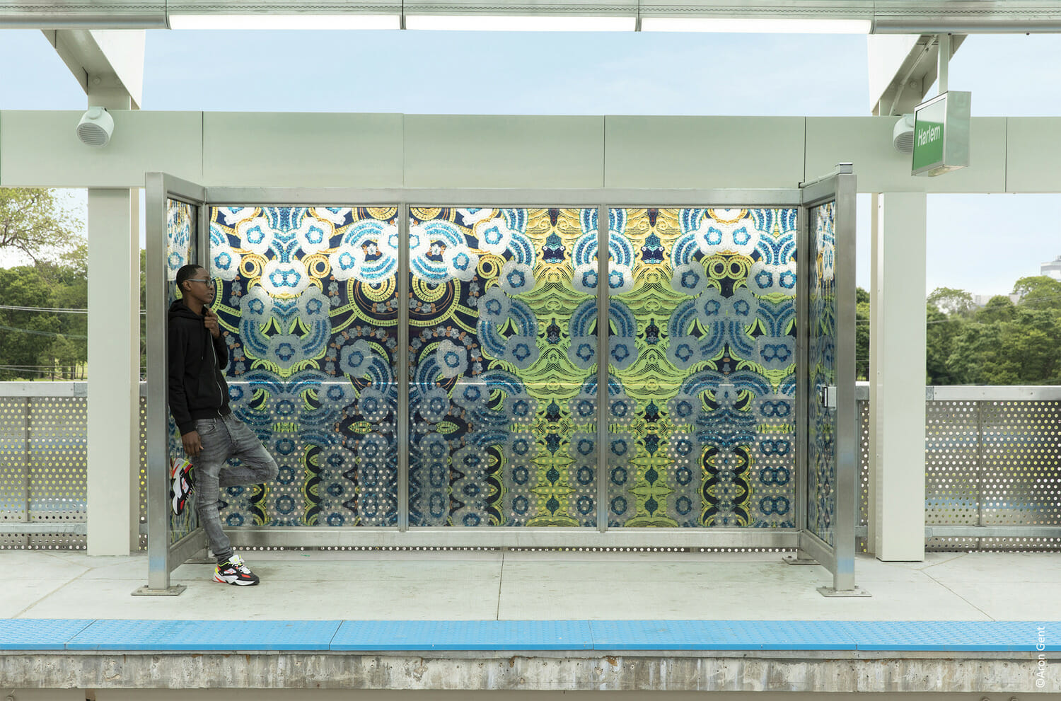 A man is standing in front of a train station.