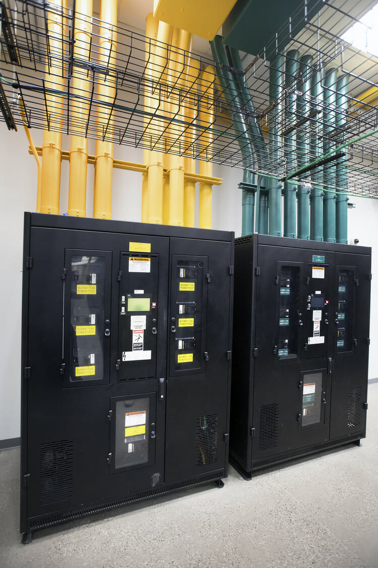 Two black and yellow electrical boxes in a room.