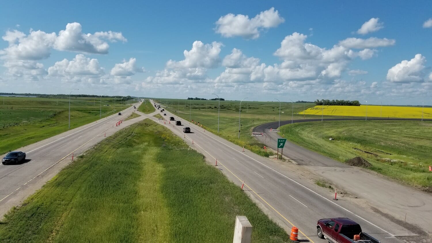 An aerial view of a highway with cars driving on it.