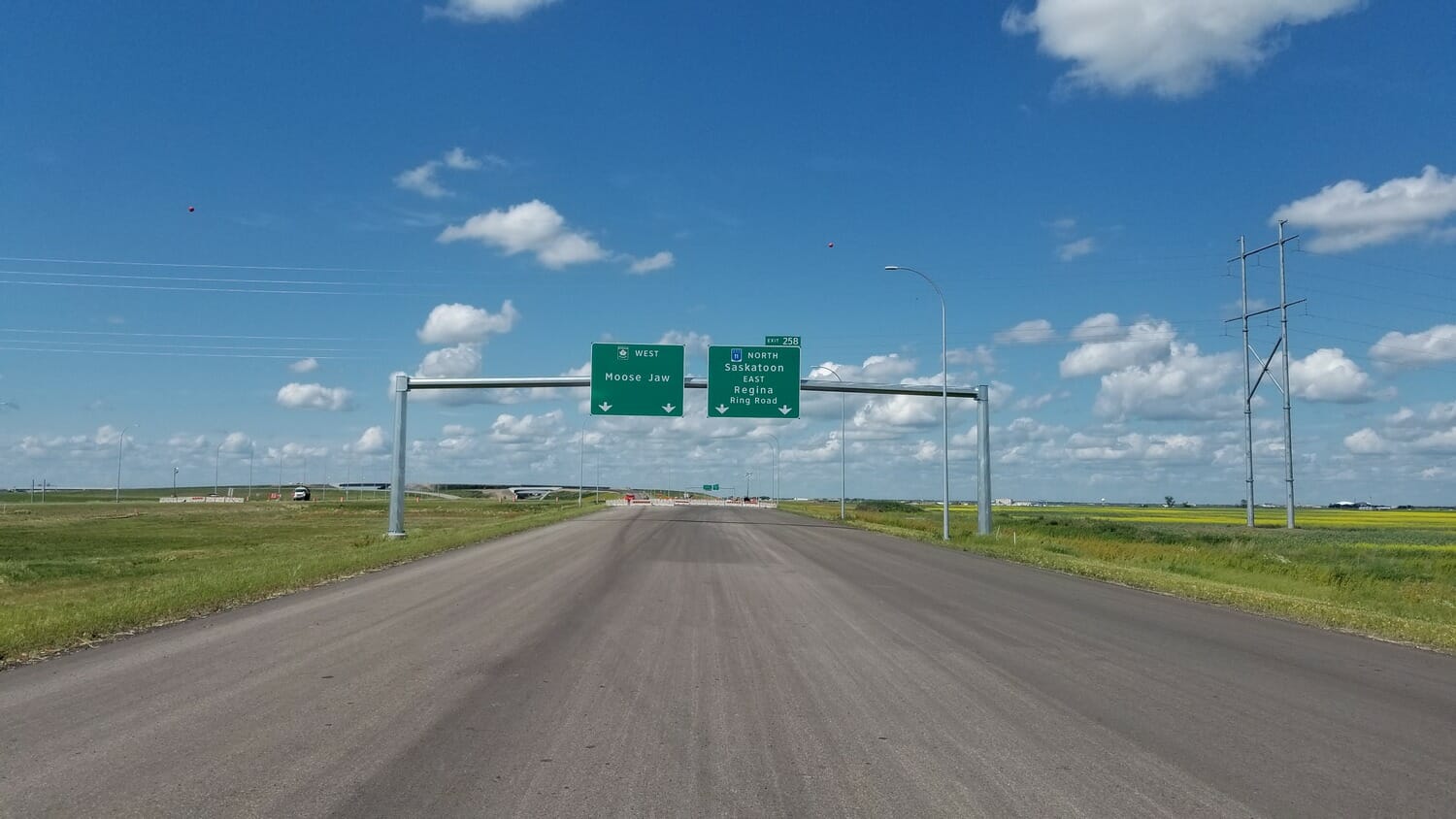 A highway with a sign in the middle of the road.