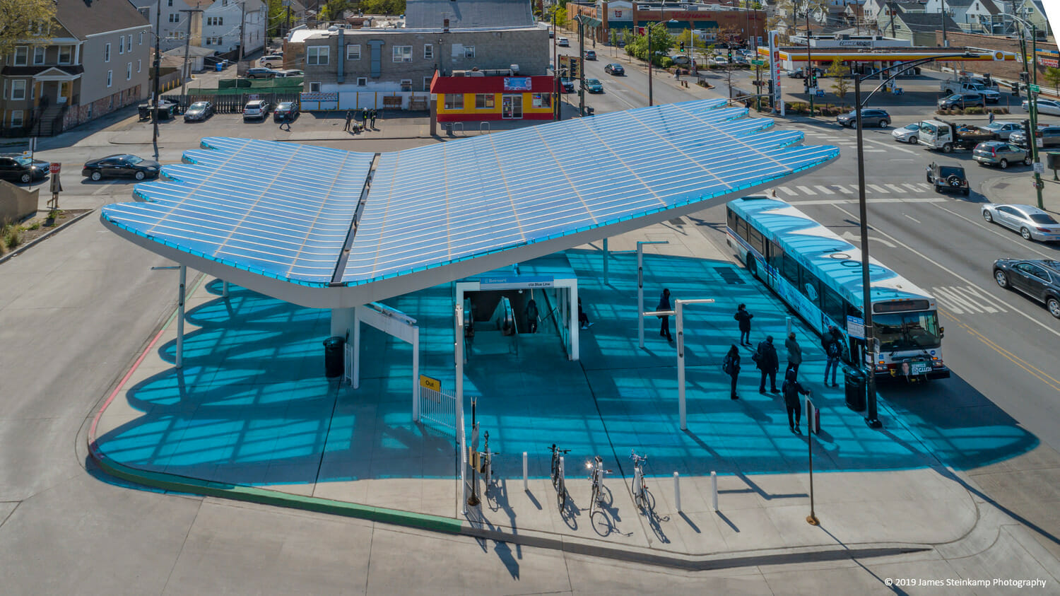 A bus stop with a blue roof.