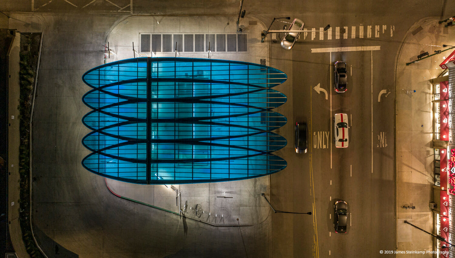 Une vue aérienne d'un bâtiment bleu la nuit.