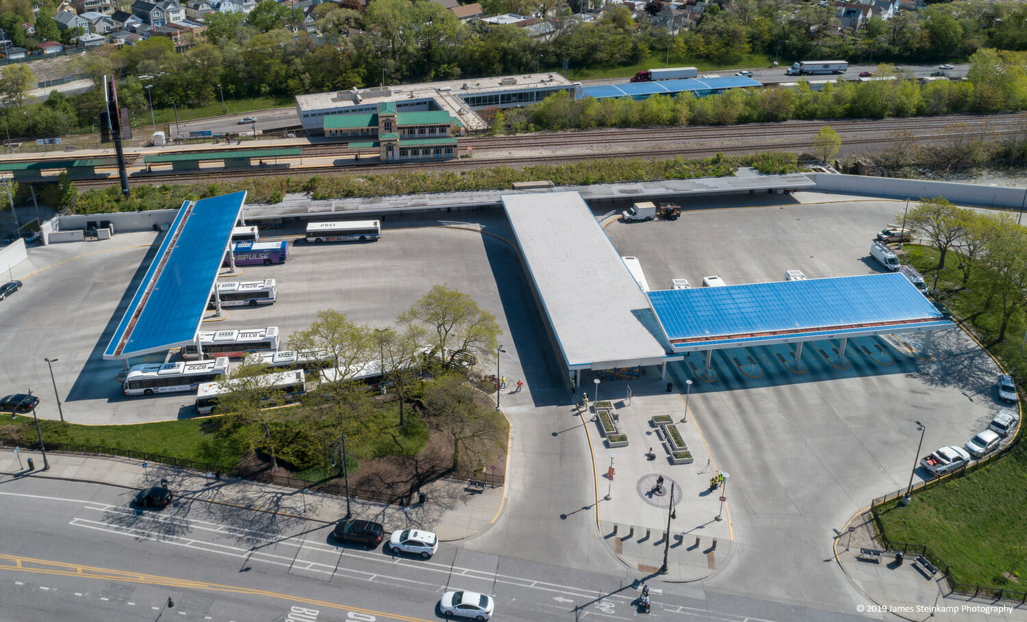 An aerial view of a parking lot with a blue roof.