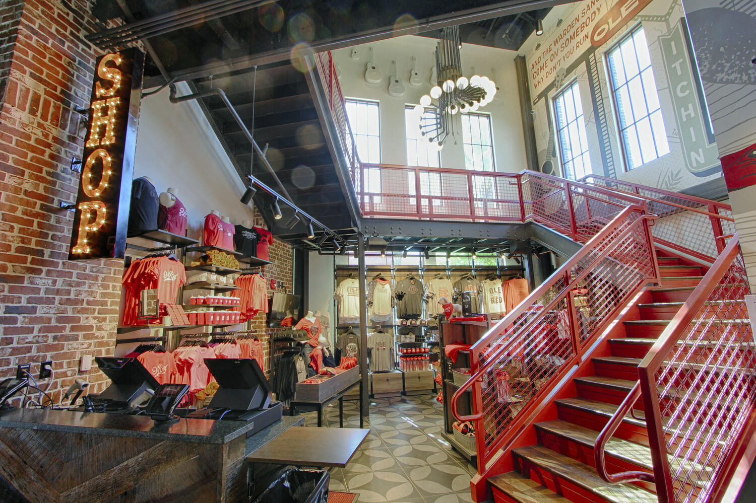 The interior of a store with a red staircase.