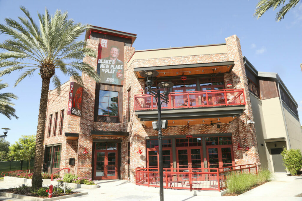 A brick building with a palm tree in front of it.