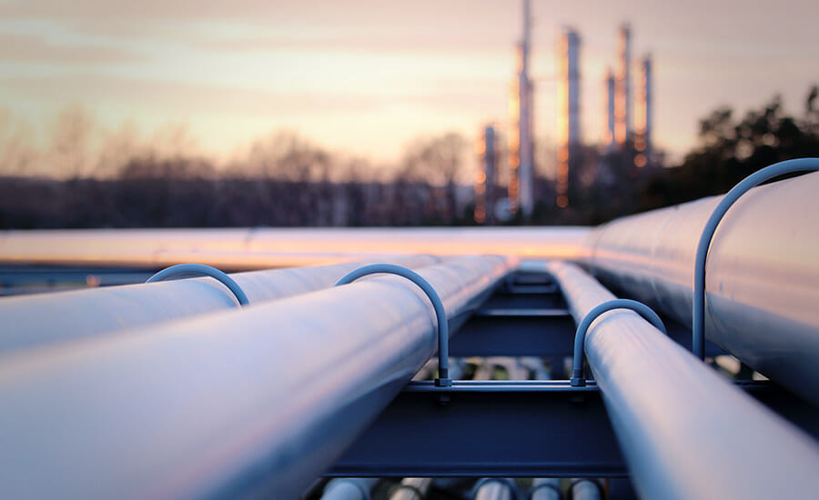 A close up of a group of pipes at sunset.