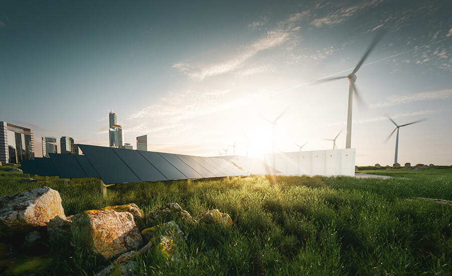 Solar panels and wind turbines in a grassy field.