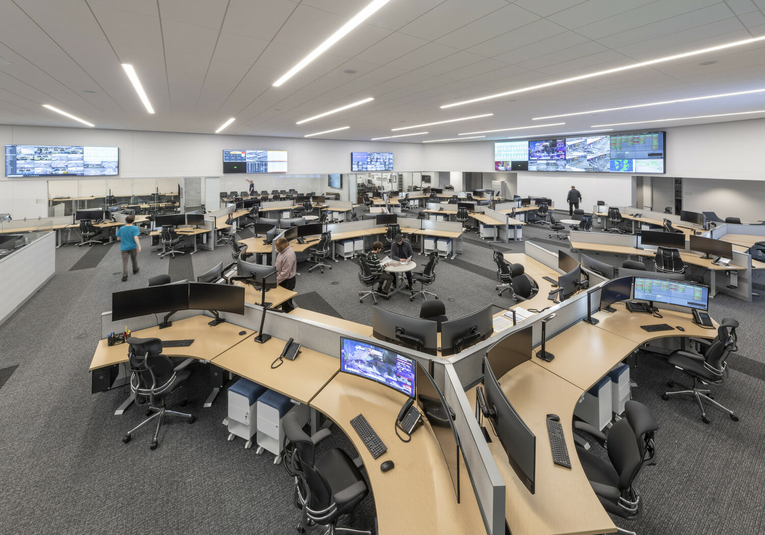 A large room with many desks and monitors.