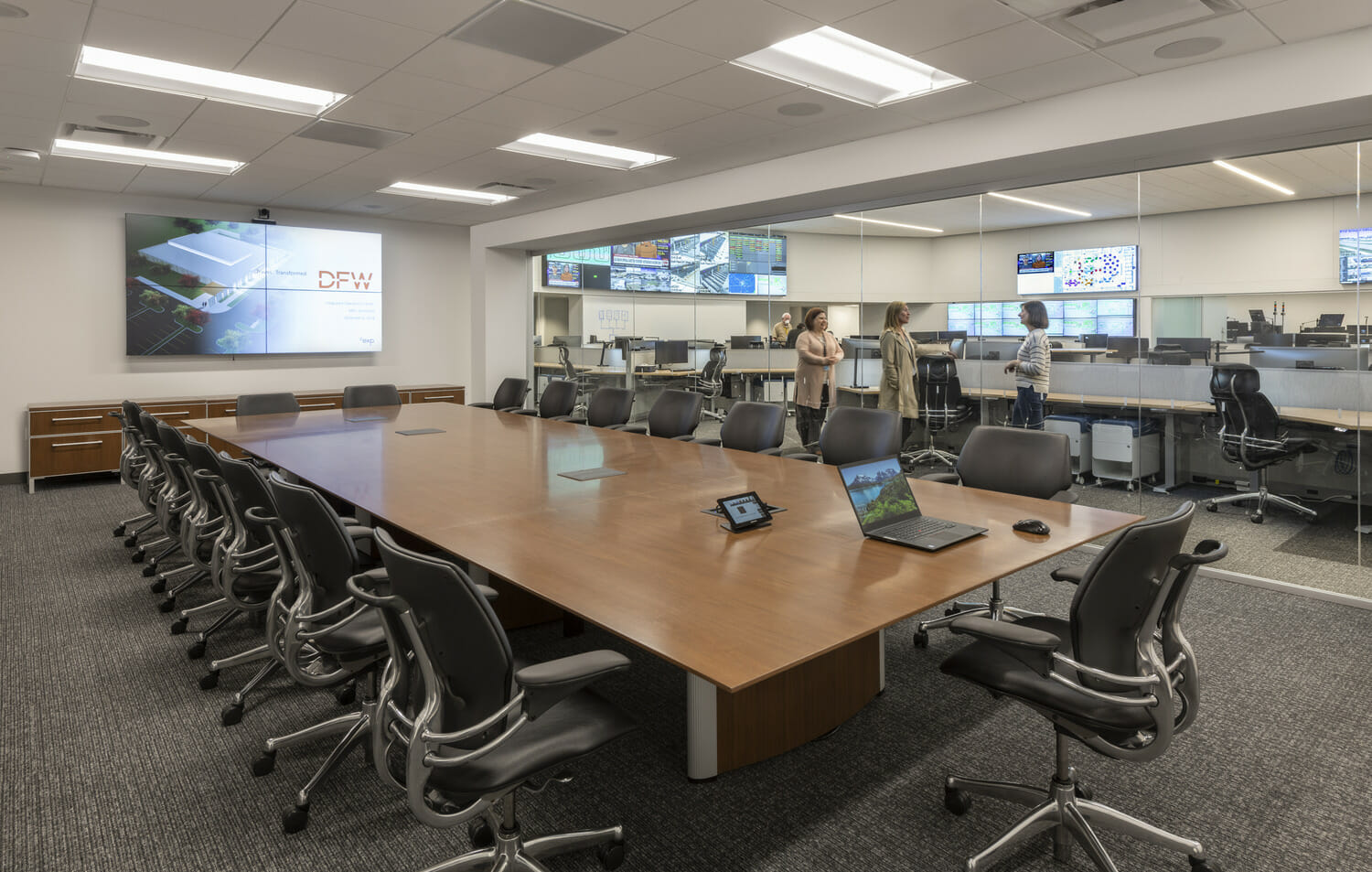 A conference room with a large table and chairs.