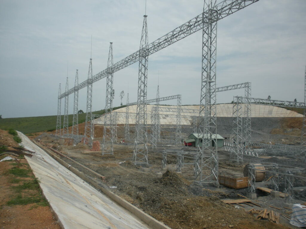 The construction of a large power line in a field.