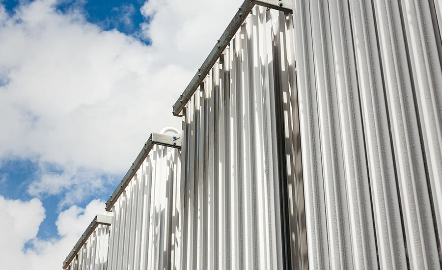 Corrugated metal panels against a blue sky.