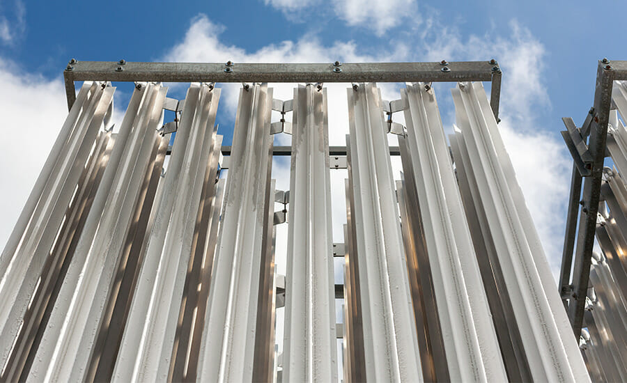 A group of metal pipes against a blue sky.