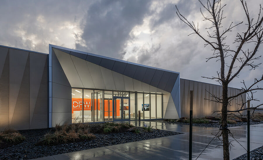 The exterior of a building with a cloudy sky.