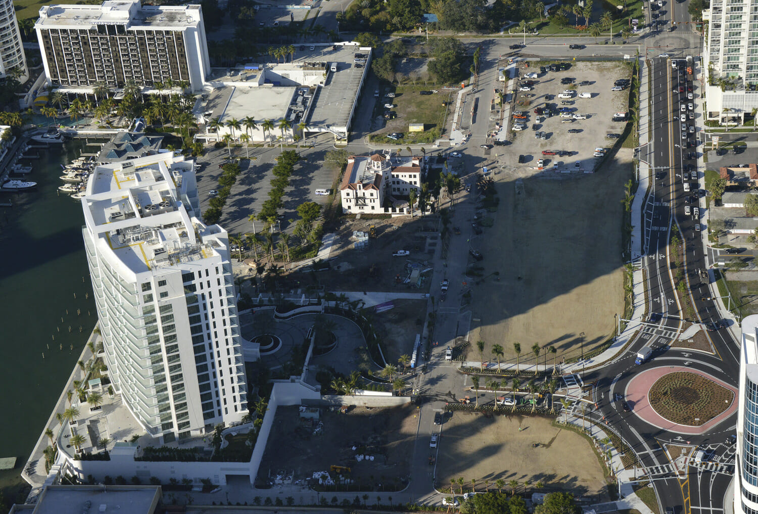 An aerial view of a city with tall buildings and a waterway.