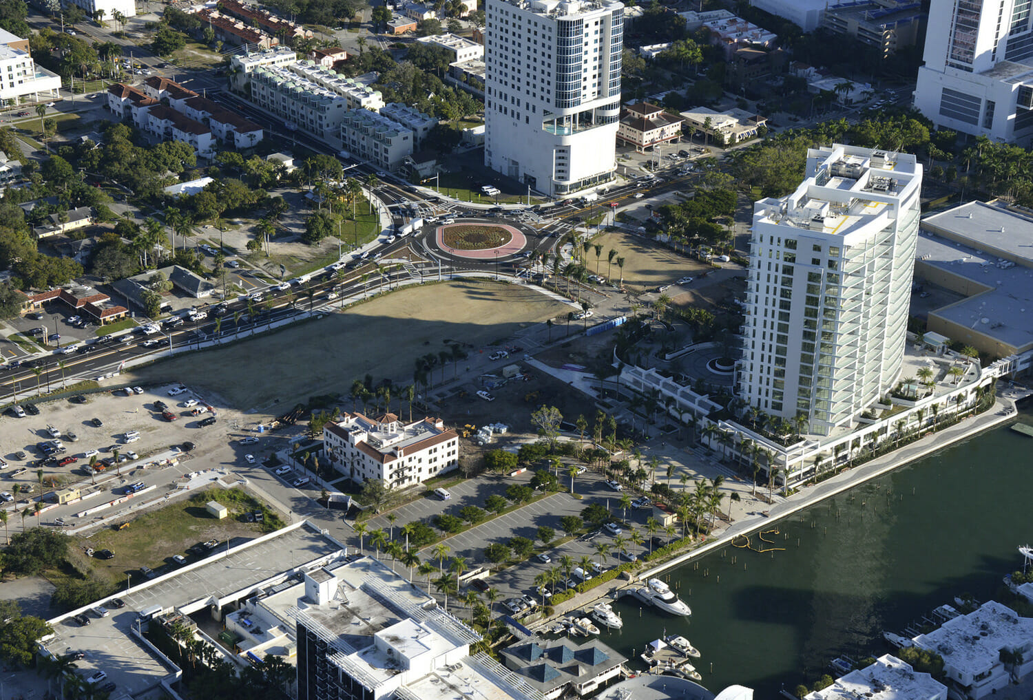 An aerial view of a city with tall buildings and a waterway.