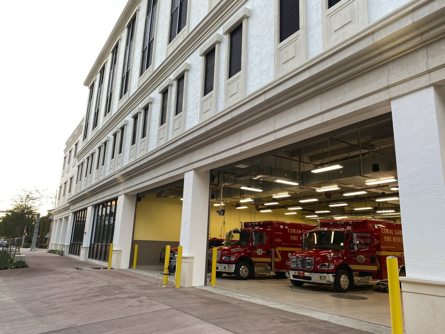 Two fire trucks parked in front of a building.