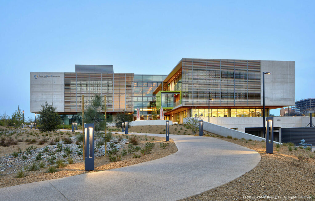 A large modern building with a pathway leading to it.