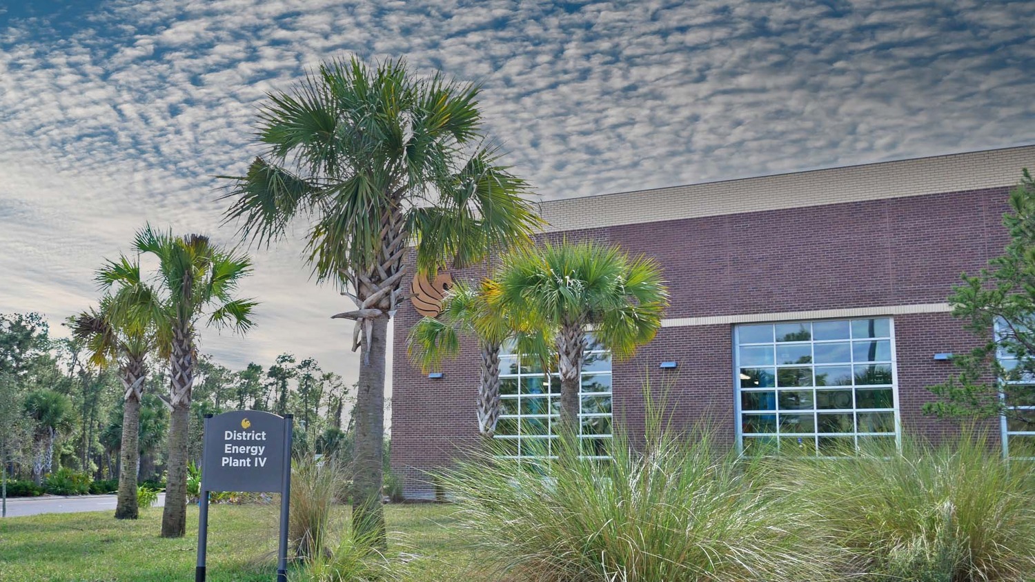 A building with palm trees in front of it.