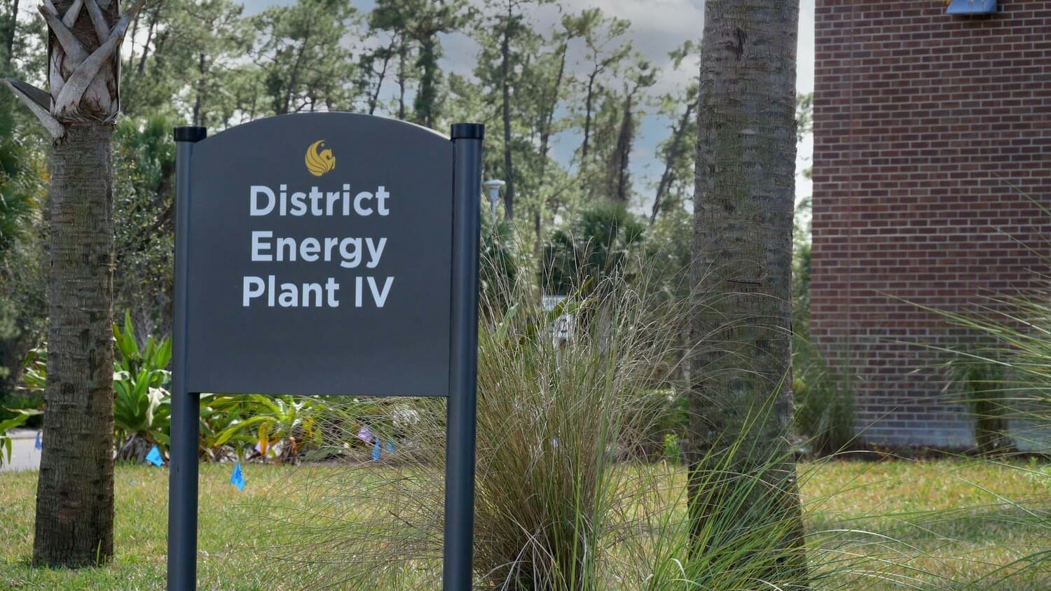A sign in front of a building that says district energy plant iv.