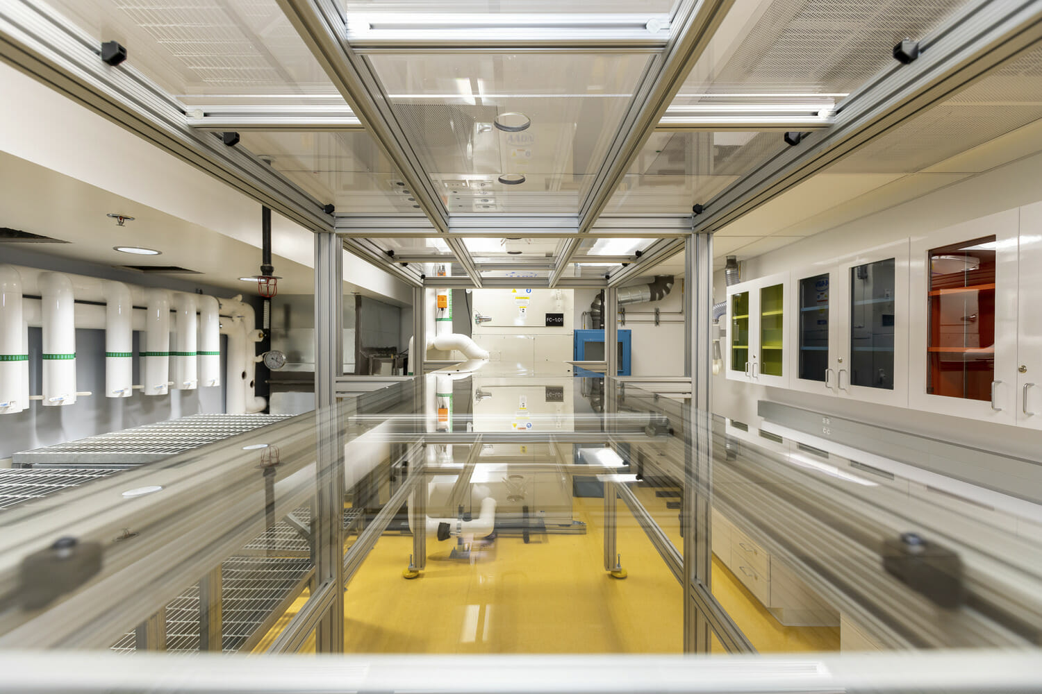 A yellow floor in a room with a lot of equipment.