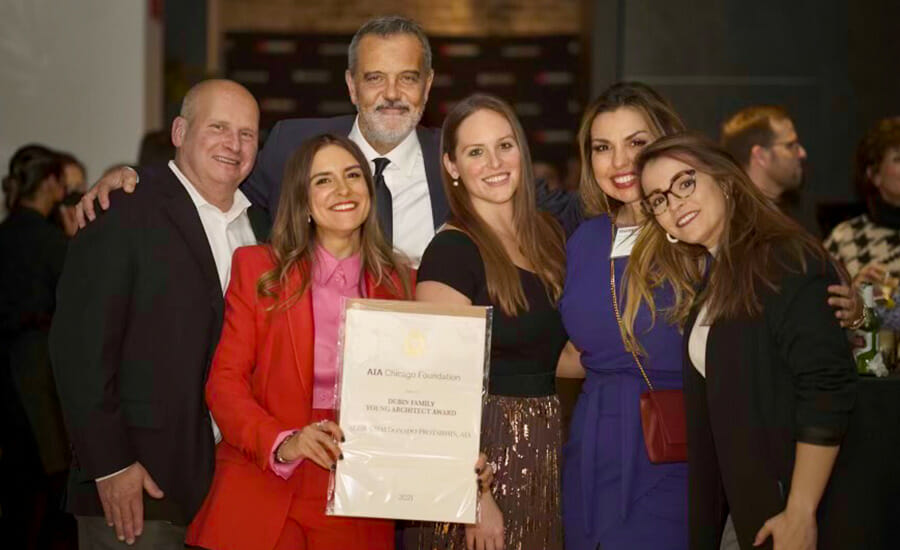 A group of people posing for a photo with an award.