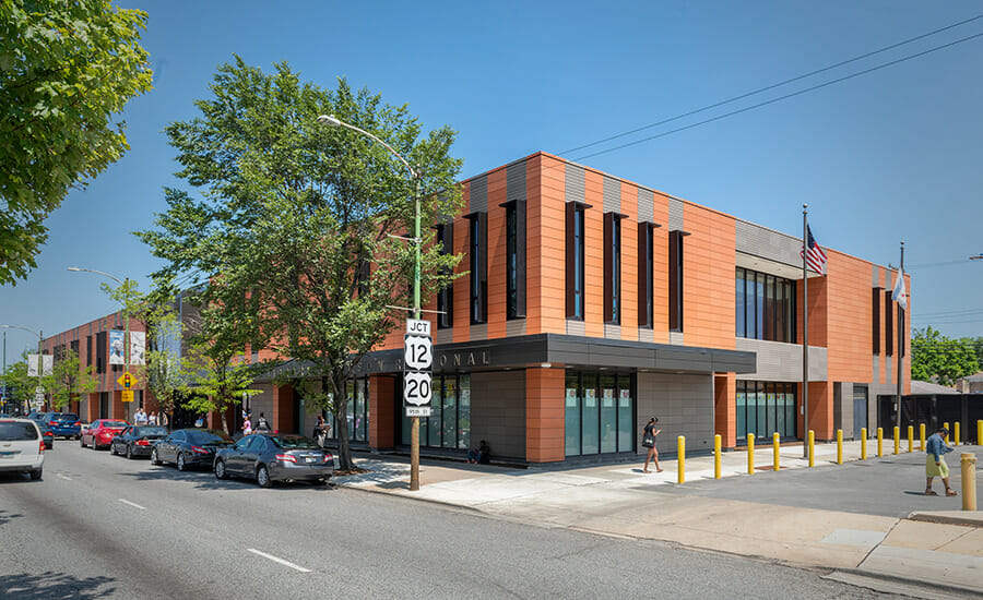 A building on a street with cars parked in front of it.