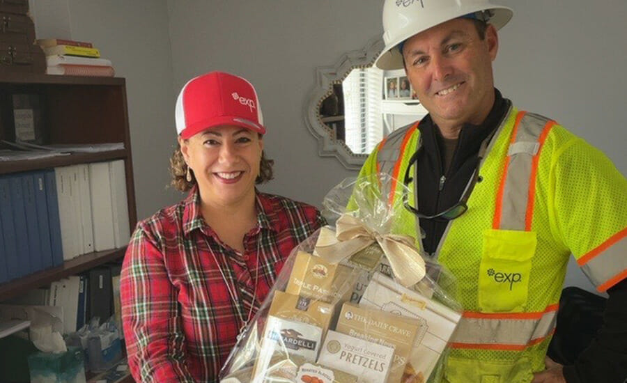 A man in a hard hat and a woman holding a basket of food.