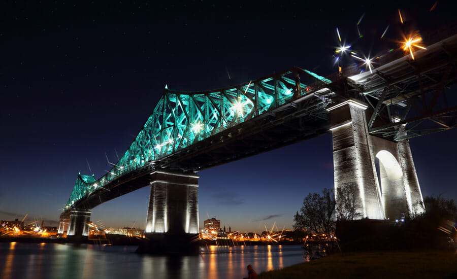 A bridge over a river at night.