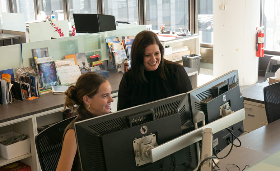 A woman is looking at a computer screen.