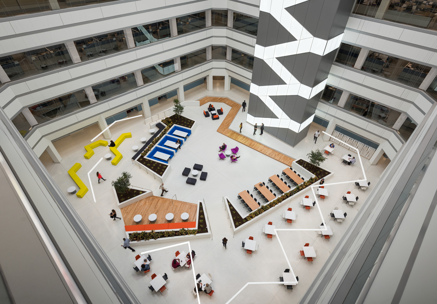 An aerial view of an office building with tables and chairs.
