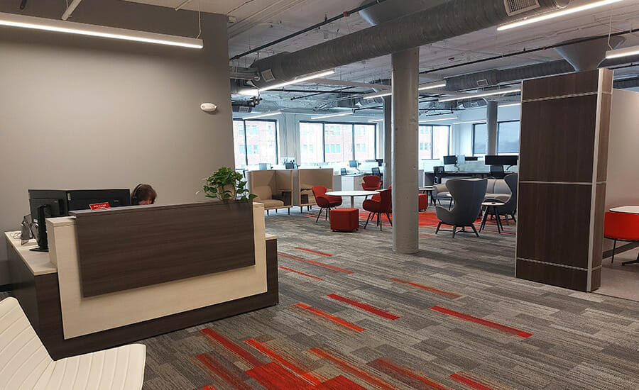 A reception area in an office with a desk and chairs.