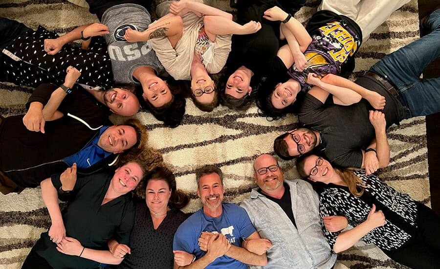 A group of people posing in a circle.