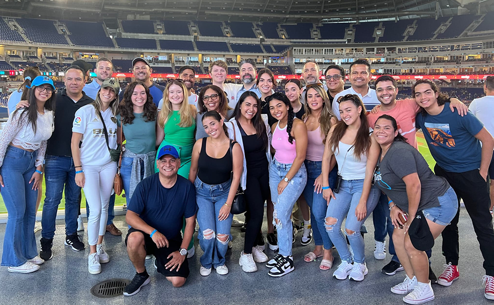 A group of people posing for a photo in a stadium.