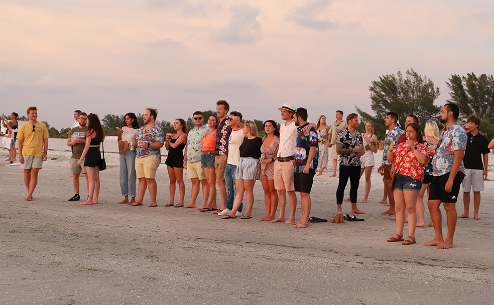 A group of people standing on a beach.