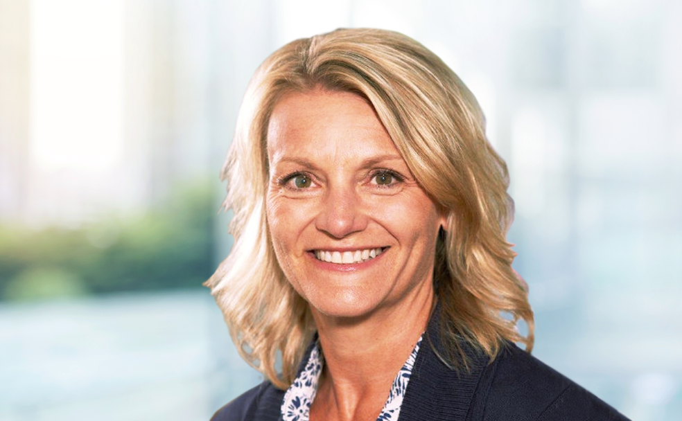 A smiling woman in a business suit.