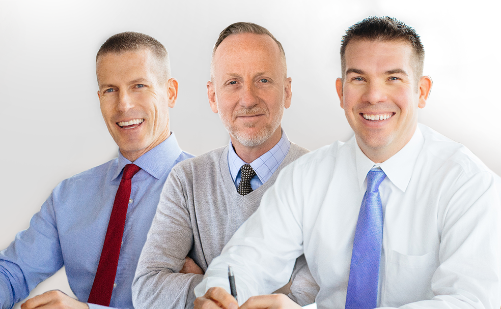 Three men sitting at a table.