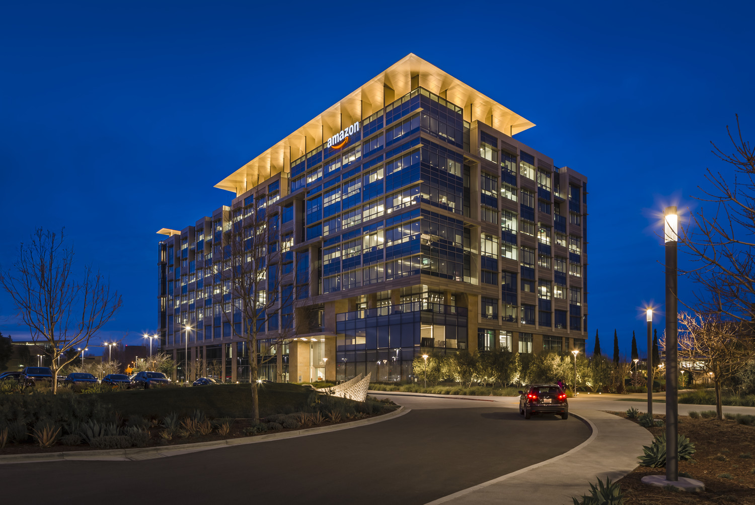 A modern office building lit up at night.