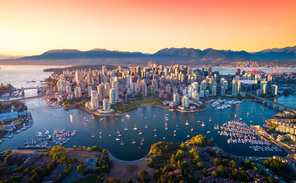 An aerial view of the city of vancouver at sunset.