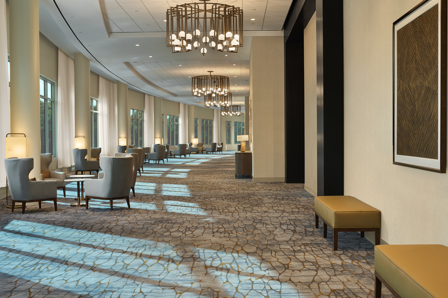 The lobby of a hotel with large windows.