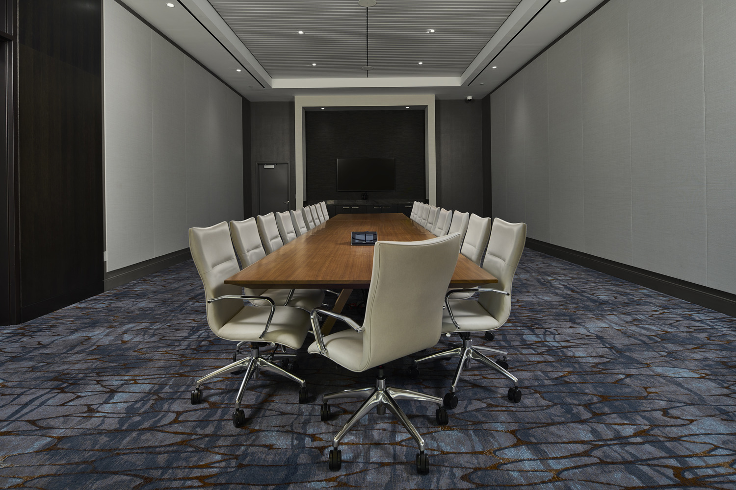 Une salle de conférence avec une grande table et des chaises.