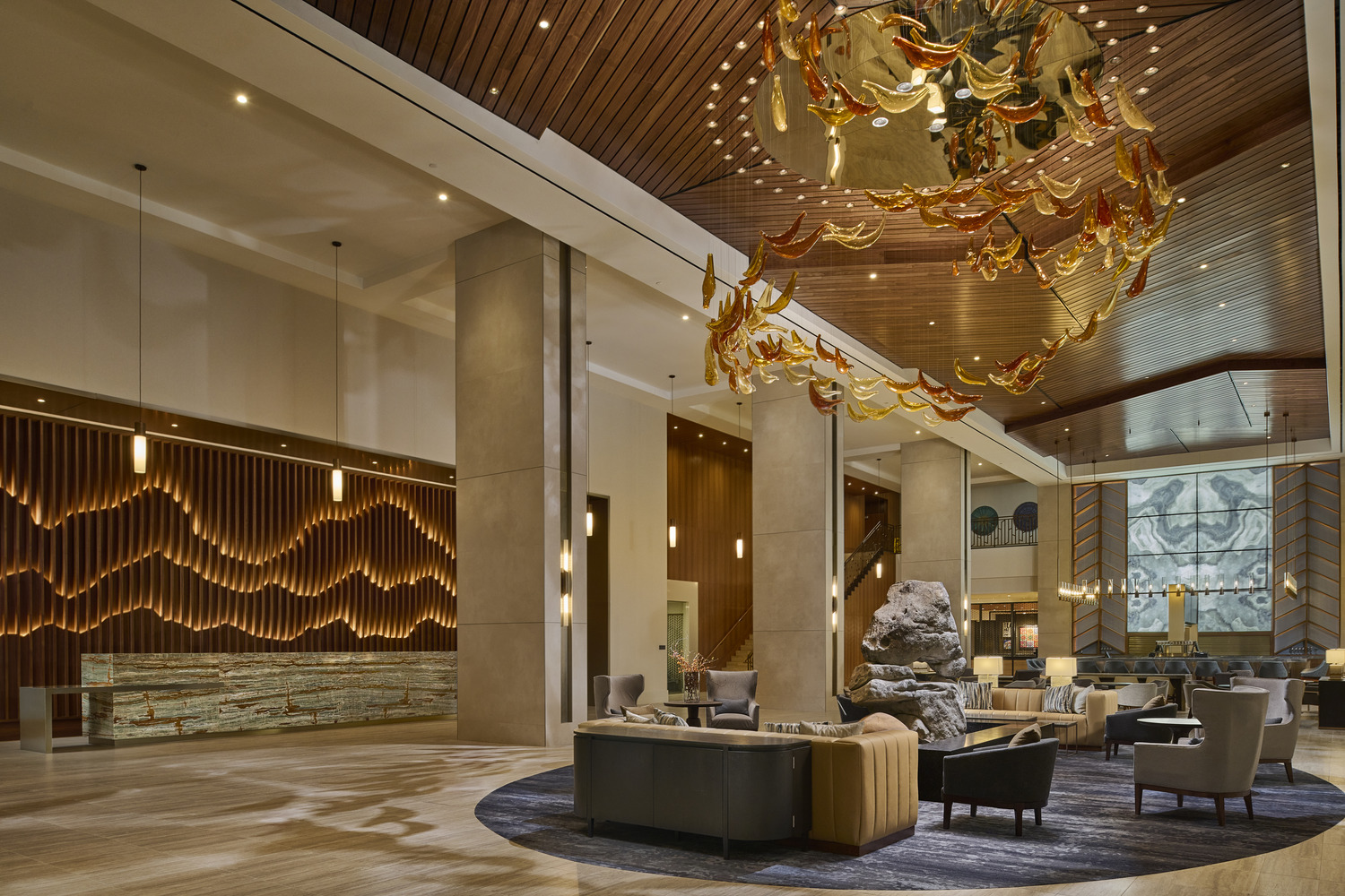 The lobby of a hotel with a large chandelier.