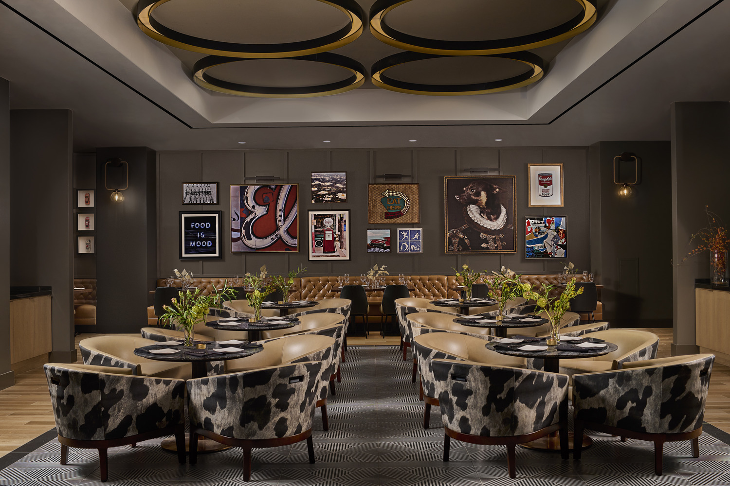 A dining room with a cow print table and chairs.