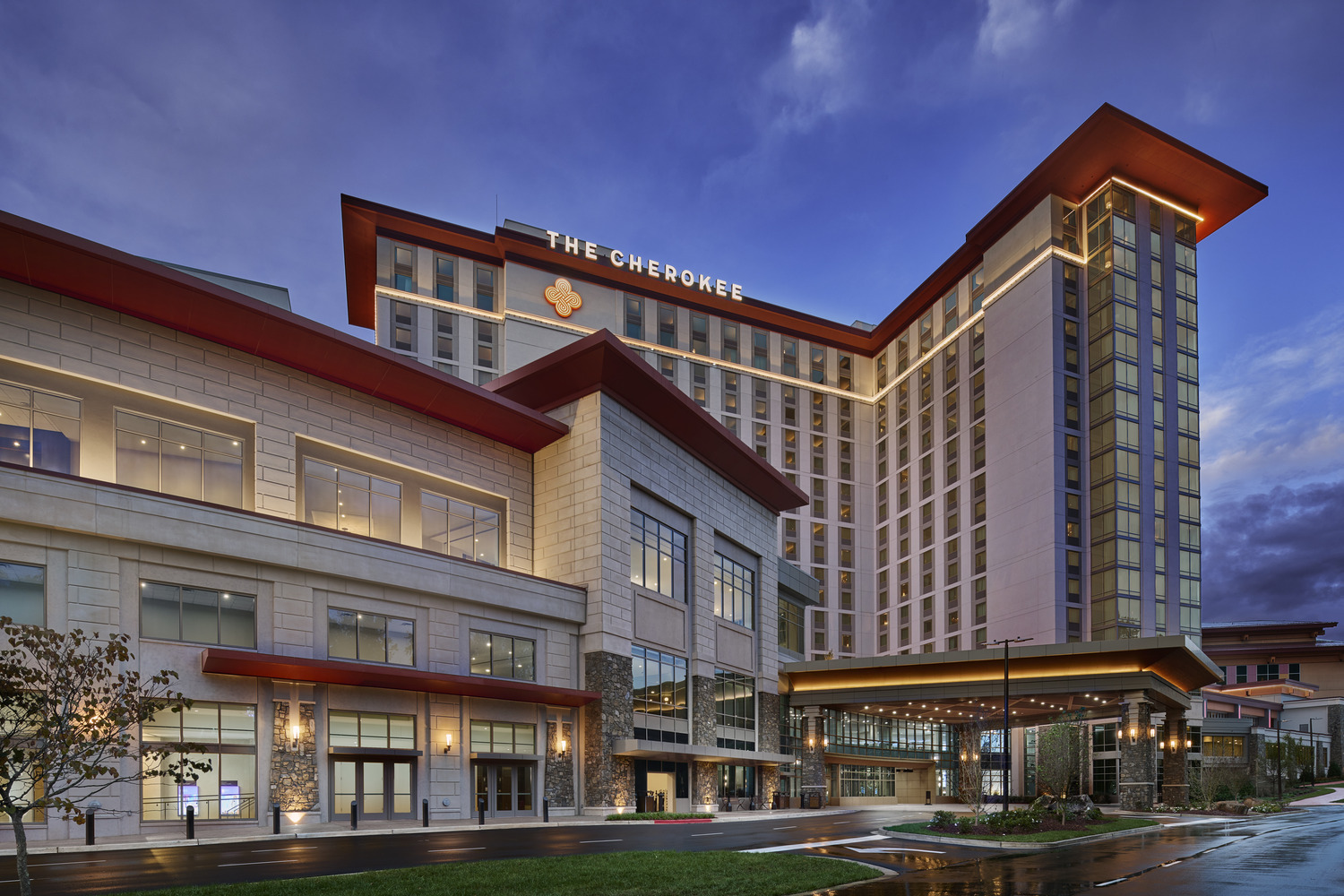 The front of a large hotel at dusk.